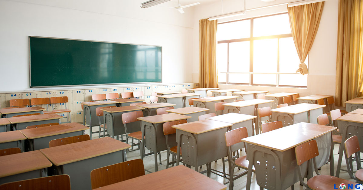 Empty classroom with desks and chalkboard